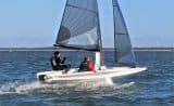 Quant 17 in foiling mode, crew no longer on trapeze, sitting to leeward, skipper relaxing on windward side deck - foiling week 2018