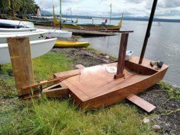 HOmemade hydrofoil stabilised dinghy - setting up on the beach before sailing